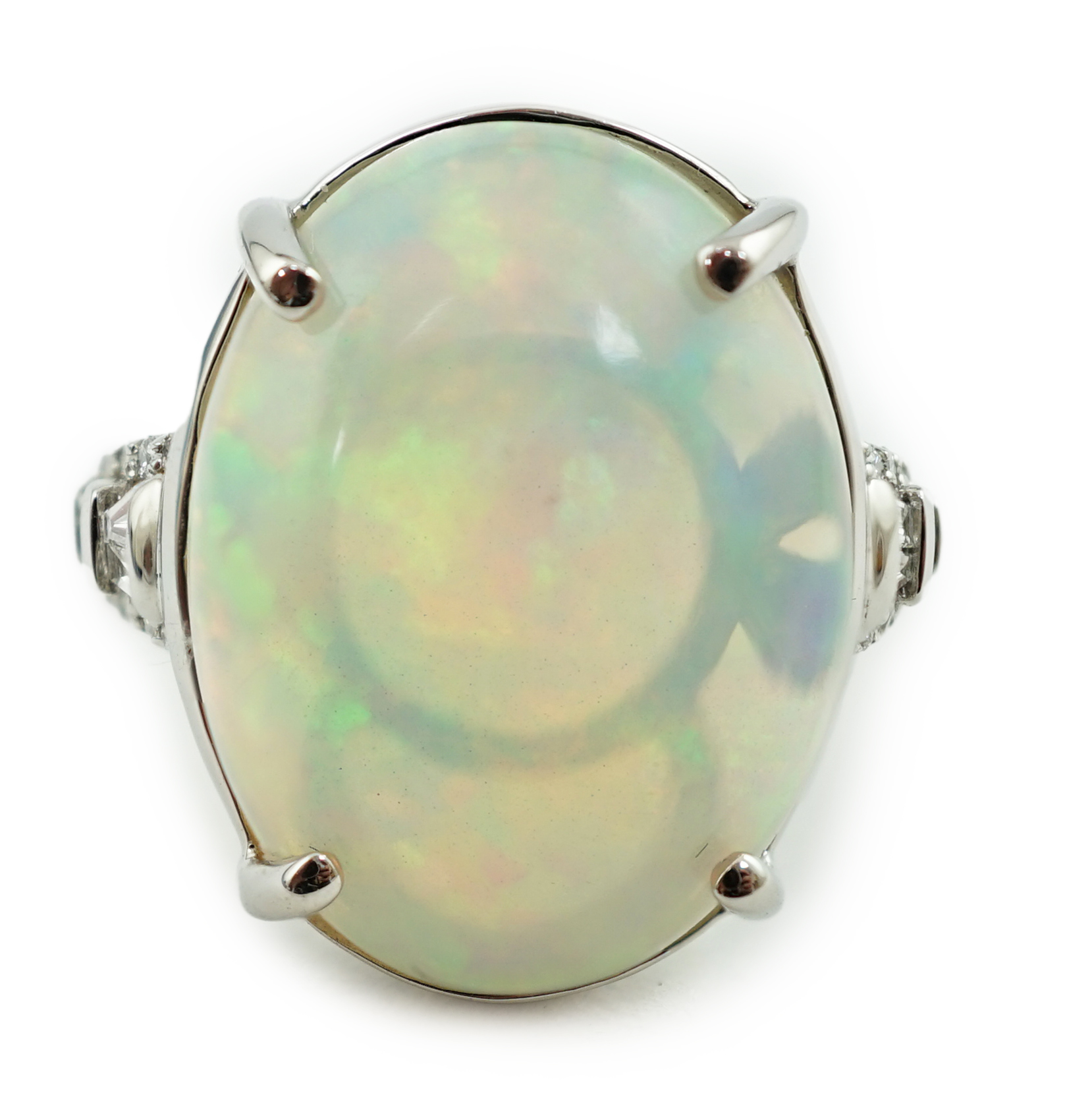 A modern Rhapsody platinum and opal white oval set dress ring, with trapeze and round cut diamond cluster set shoulders